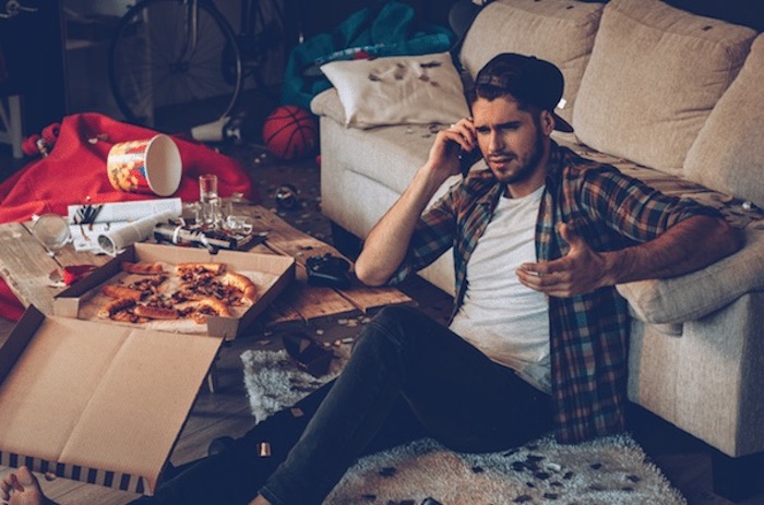 attractive guy on floor upset on the phone cleaning up for love