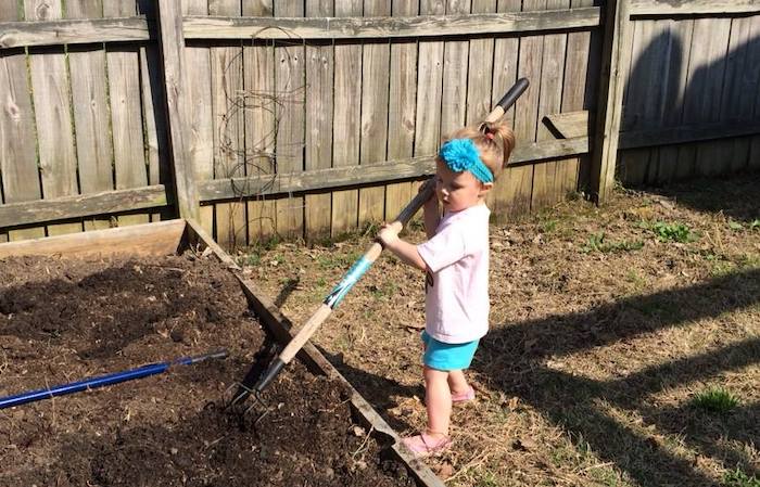 Child helping mom garden