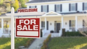 red for sale sign in front of house