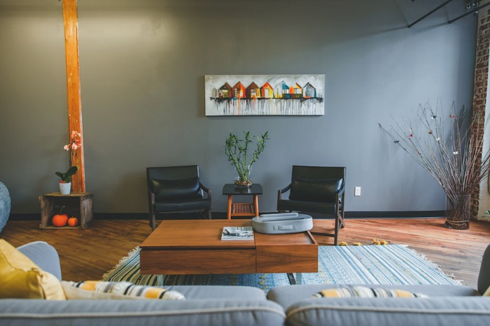 modern living room with brown hardwood floors and gray accents