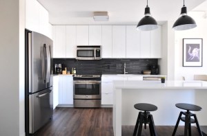 stainless steel kitchen with white counters