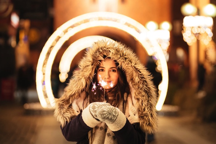 reducing holiday stress smiling woman sparklers