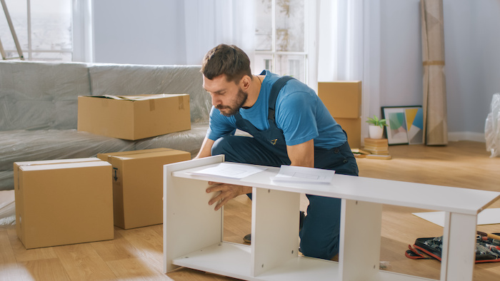 Professional closely assembling a shelf.