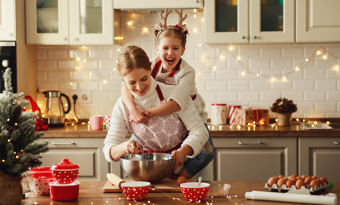 Family cooking with Christmas kitchen decor.