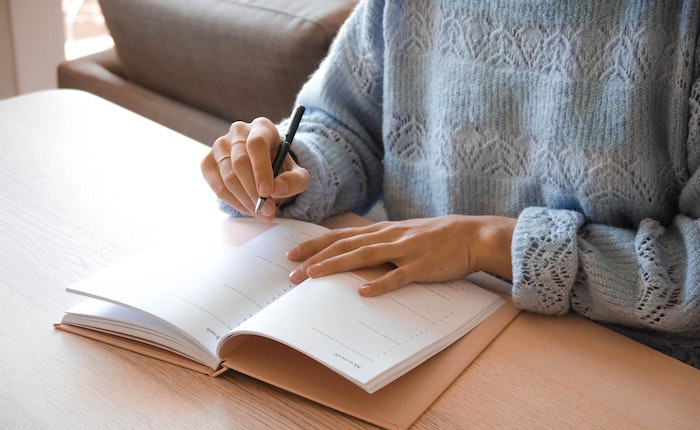 Woman creating checklist for moving