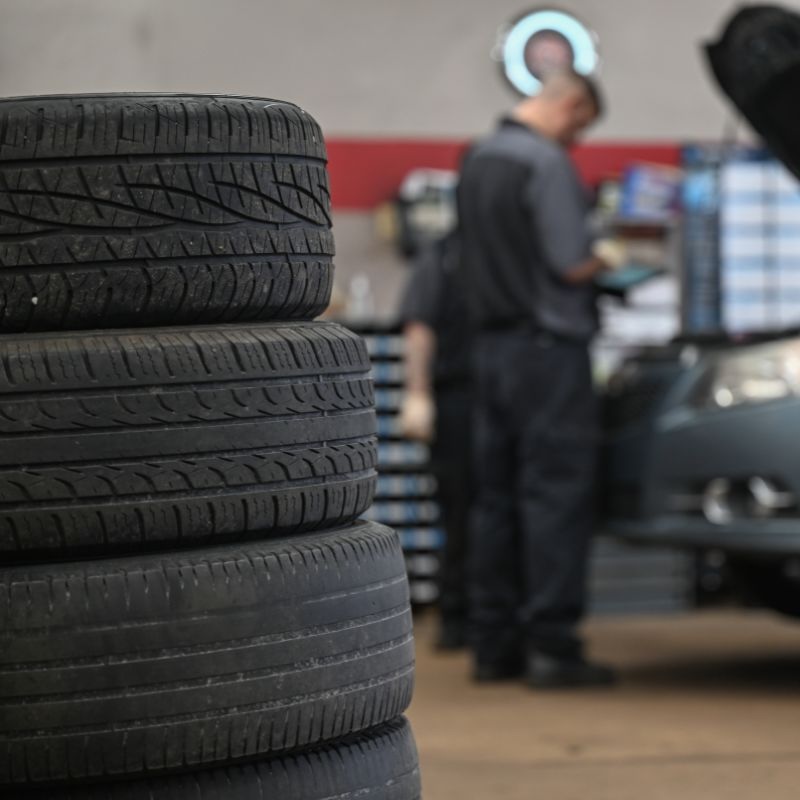 Stack of used tires ready for disposal pickup.