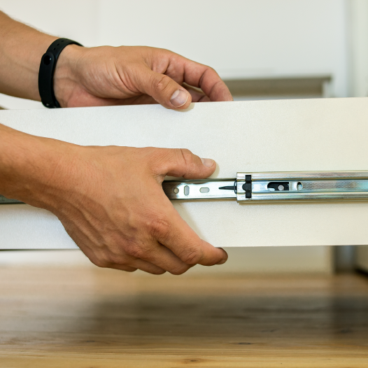 Brand new dresser being assembled by professional handyman