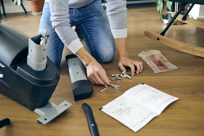 Brand new elliptical being assembled by professional handyman