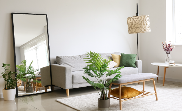 Floor mirror leaning on a modern living room wall ready for pickup