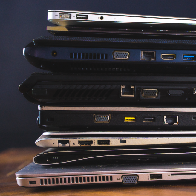 Stack of broken laptops ready for professional haul away