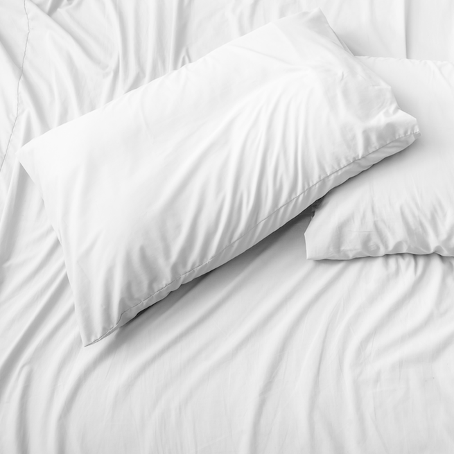Set of white pillows on a bed