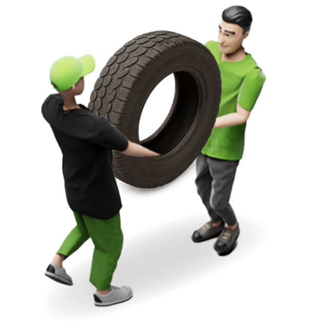 Two junk removal pros carrying an old tire to be professionally disposed of