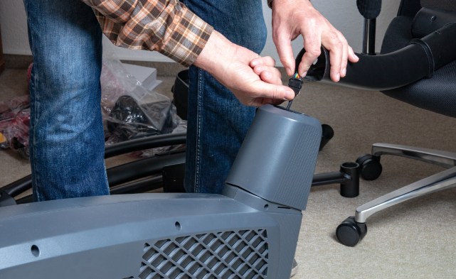 Professional elliptical assembler putting together an elliptical machine