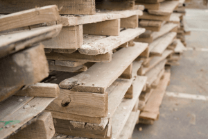 Stack of old wooden pallets creating clutter.