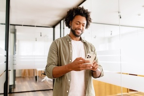 Man smiling at smartphone